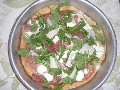 Pizza con prosciutto crudo, rucola e scaglie di parmigiano